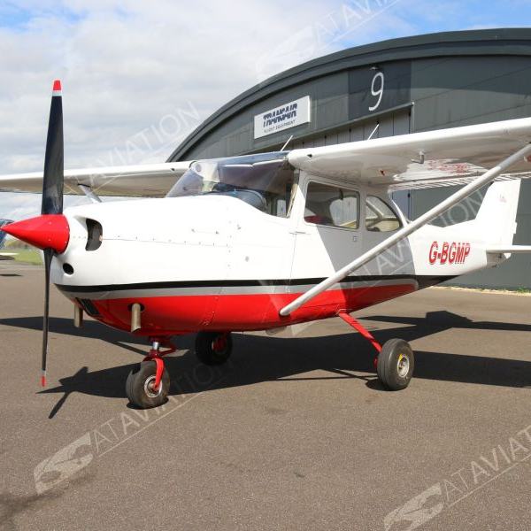 1965 Cessna F172G Single Engine Piston Airplane For Sale on AvPay by AT Aviation. In front of the hangar