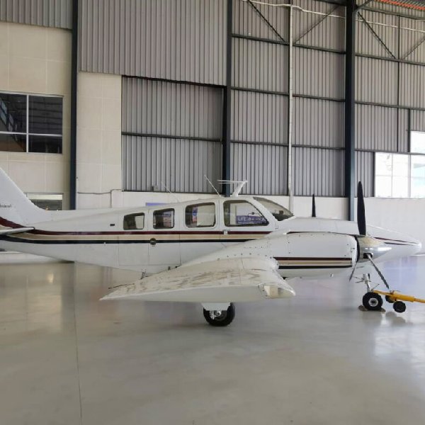 1973 Beechcraft Baron 58 for sale by Aerostratus. Parked in the hangar