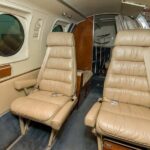 1979 Beechcraft King Air C90 turboprop airplane for sale on AvPay by Jetron. Interior facing rear