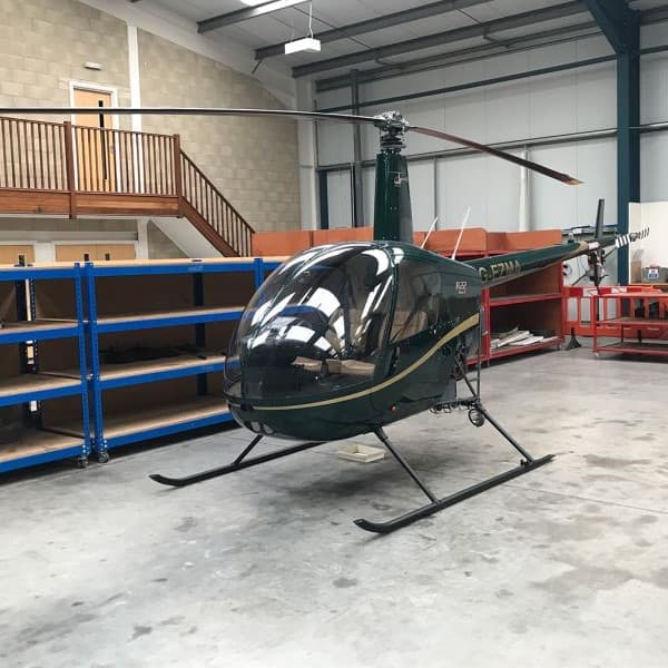 1999 Robinson R22 BETA 2 for sale by Europlane Sales. Parked in hangar-min