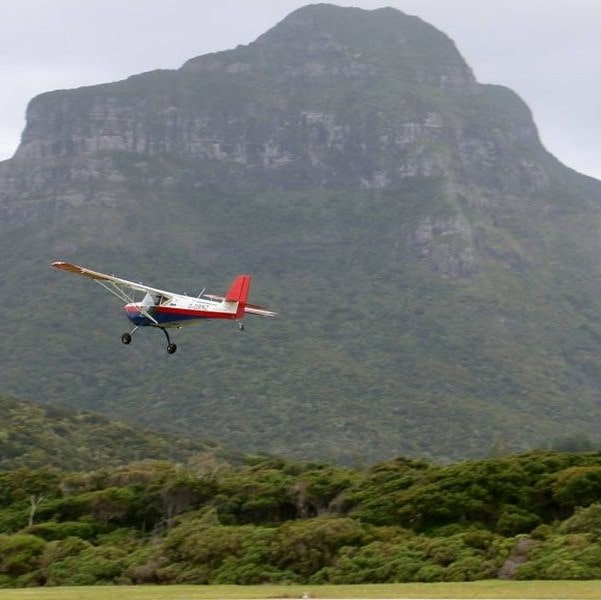 Aeropro in flight with mountain