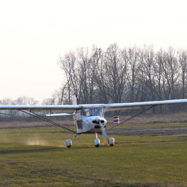 Aeros aeroplane taking off from grass runway