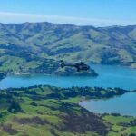 Akaroa & Banks Peninsula Scenic Flight From Christchurch Helicopters helicopter in flight over fields and water
