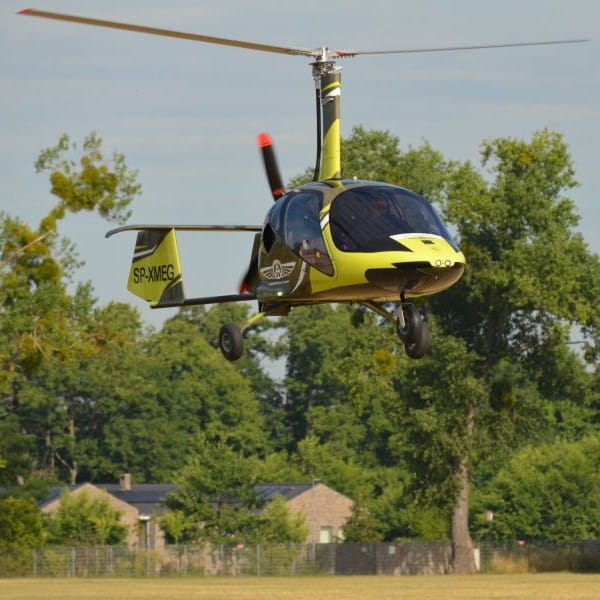 Aviation Artur Trendak gyrocopter hovering over field