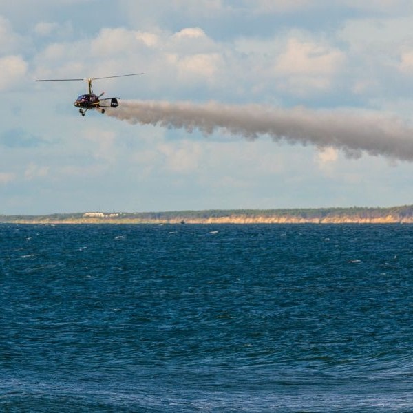 Aviation Artur Trendak gyrocopter spraying over water