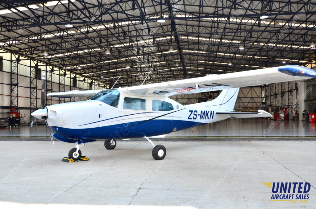 Cessna T210M Centurion Single Engine Piston Airplane For Sale on AvPay by United Aircraft Sales. Parked in front of the hangar