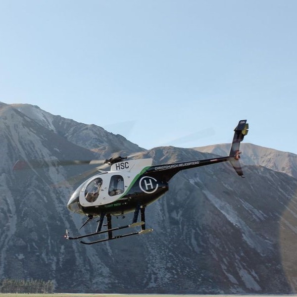 Christchurch Helicopters Gallery. Hughes helicopter flying through the mountains