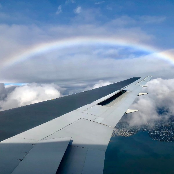 Comlux gallery. Rainbow over the wing of an aircraft
