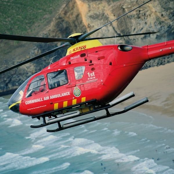 Cornwall Air Ambulance helicopter flying over beach