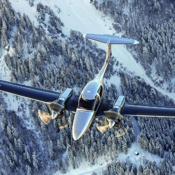 DIAMOND DA42-IV airplane for sale on AvPay by Egmont Aviation. Flying over a wintery forest