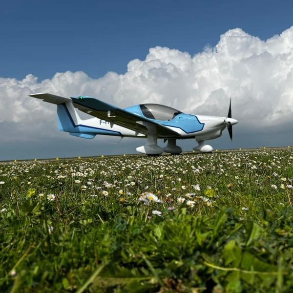 Elixir plane on field with blue skies