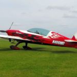 Extra 300 LP red plane landed on grass