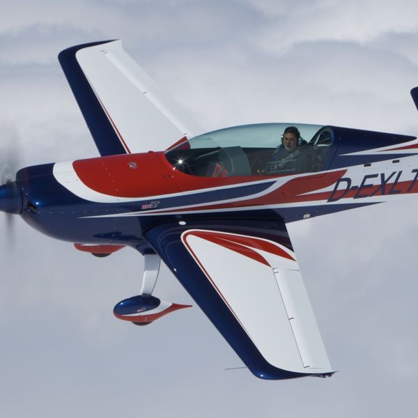 Extra 330 LT in flight above the clouds