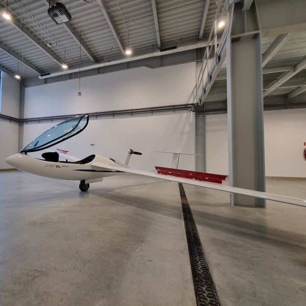 GP-Gliders-parked-in-the-hangar-with-canopy-and-air-brakes-open-min