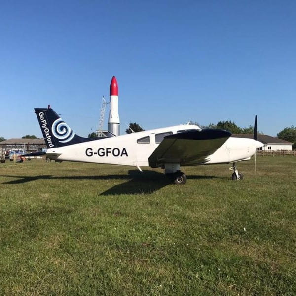 Go Fly Oxford Piper Warrior parked on the grass-min