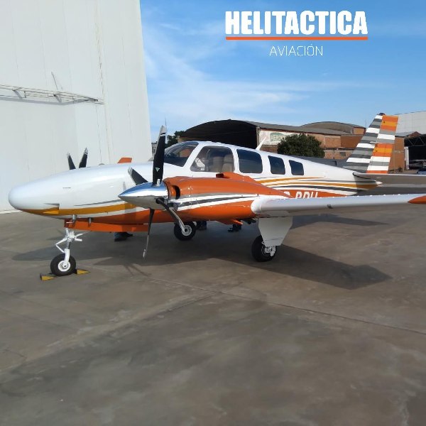 Helitactica stationary plane outside hangar