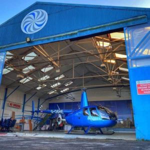 VIP Waiting Lounge & The Viewpoint at Elstree Aviation Centre: Out of Hours. Blue Robinson R44 parked at the entrance of the Elstree Aviation Centre Hangar.