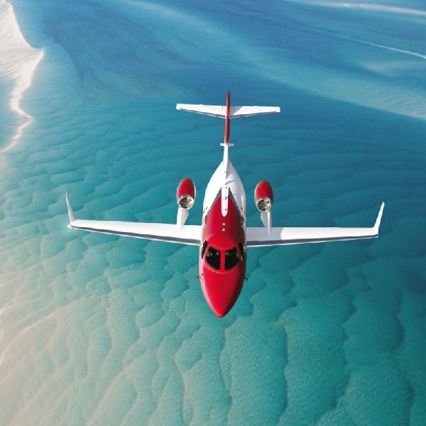 Kull Jet on AvPay jet flying over clear water