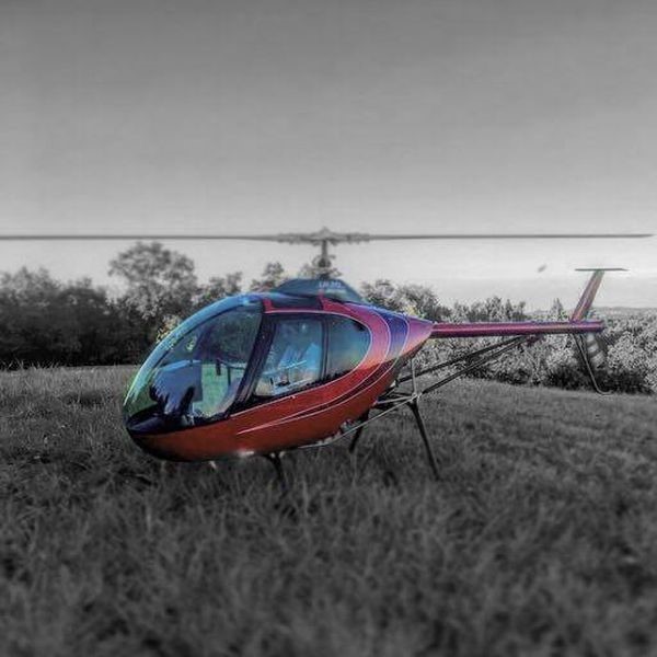 Lamanna Helicopter. Red helicopter parked in the countryside
