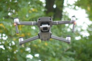 Mavic 2 drone flying below trees