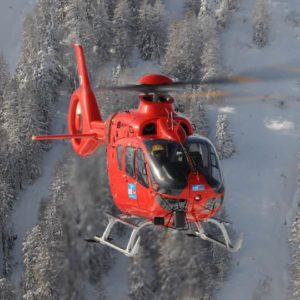 New Airbus H135 Turbine Helicopter For Sale by Ostnes Helicopters. Flying over snowy mountain