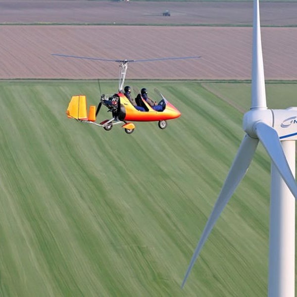 New AutoGyro MTO Classic Gyrocopter Aircraft For Sale in flight passing wind turbine