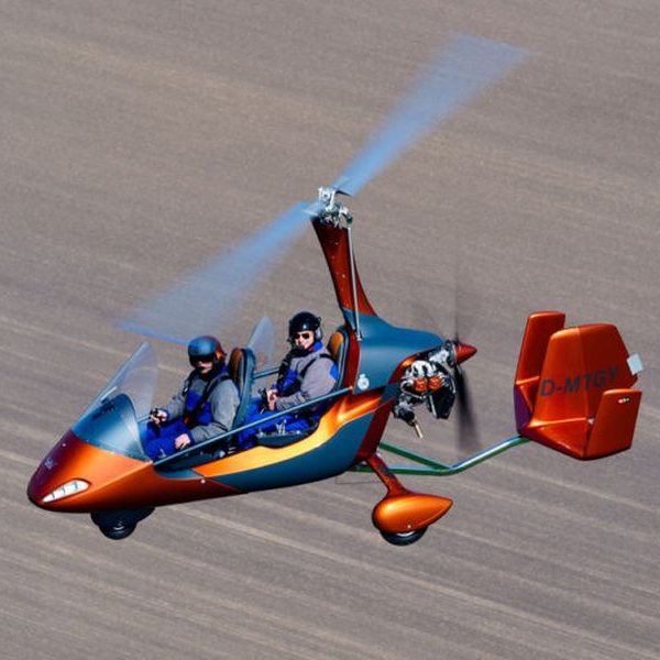 New AutoGyro MTO Sport Gyrocopter Aircraft For Sale in flight over farmed fields