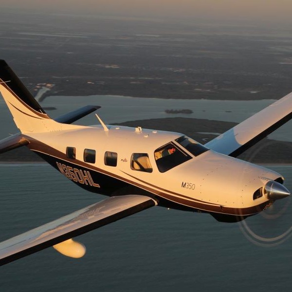 New Piper M350 Single Engine Piston Aircraft For Sale in flight over coast