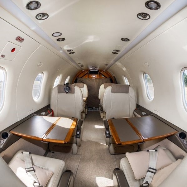 Pilatus PC12 Private Jet For Charter In Biggin Hill From Fly 7 interior seating with tables