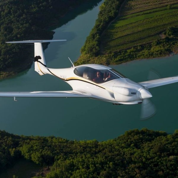 Pipistrel Aircraft in flight over river and fields