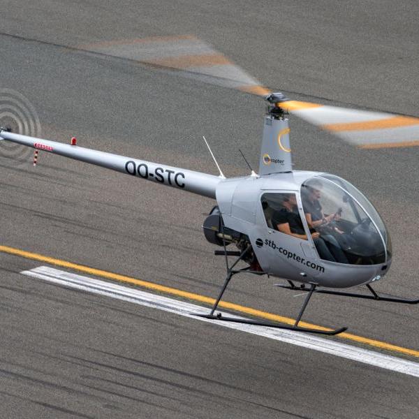 Robinson R22 Piston Helicopter For Hire At STB Copter flying over runway