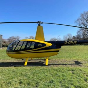 Robinson R44 Raven I For Sale by Flightline Aviation. Aircraft parked on the grass-min