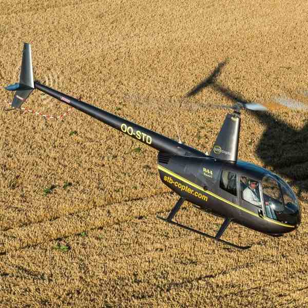 Robinson R44 (STD) Piston Helicopter For Hire At STB Copter in flight over fields