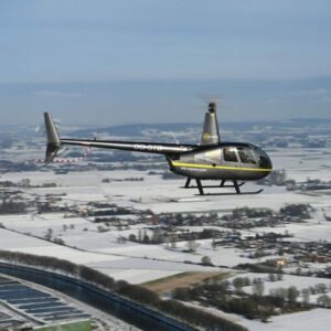 STB COPTER on AvPay helicopter flying over snow covered landscape close