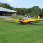 Scheibe SF-25C Falke parked in front of the hangar-min