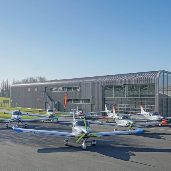 Soneca group of planes outside hanger