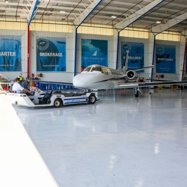 Southern Sky Aviation. Citation Jet being towed out of the hangar-min