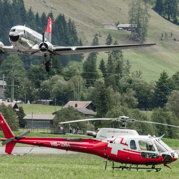 Swiss Helicopter Gallery on AvPay. C47 Dakota landing behind an Airbus H125
