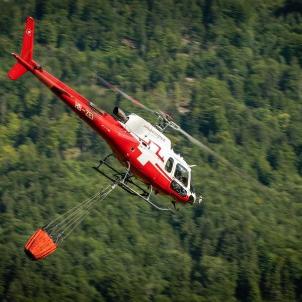 Swiss Helicopter Gallery on AvPay. Helicopter carrying water bucket