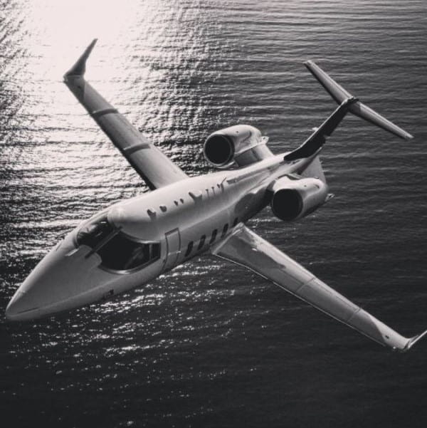 Symphony Private Jets Learjet Flying over the sea
