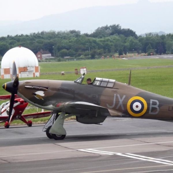 The Aviator Airfield Cafe at Gloucester Airport Hawker Hurricane parked in front of cafe