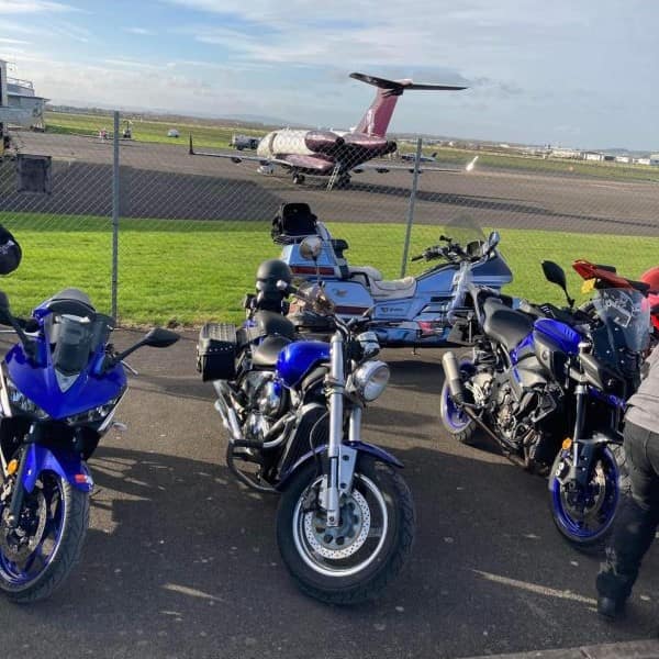 The Aviator Airfield Cafe at Gloucester Airport bikes parked in front of a private jet