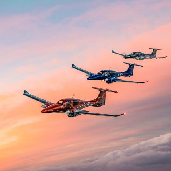 Three planes flying at sunset