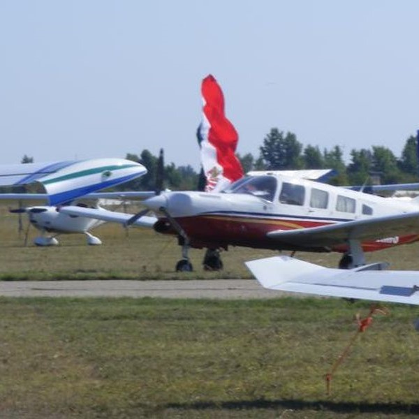 Tököl Airport Aircraft parked on the grass in front of a banner