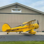 Waco Air Museum aircraft parked in front of hangar-min