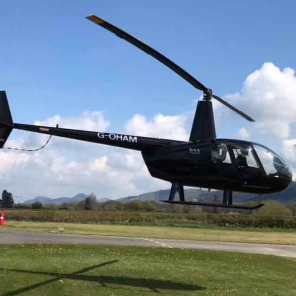 Whizzard Helicopters Robinson R44 departing Welshpool Airport-min